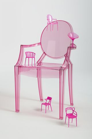 Barbie x Kartell pink chair with smaller chairs balancing on it