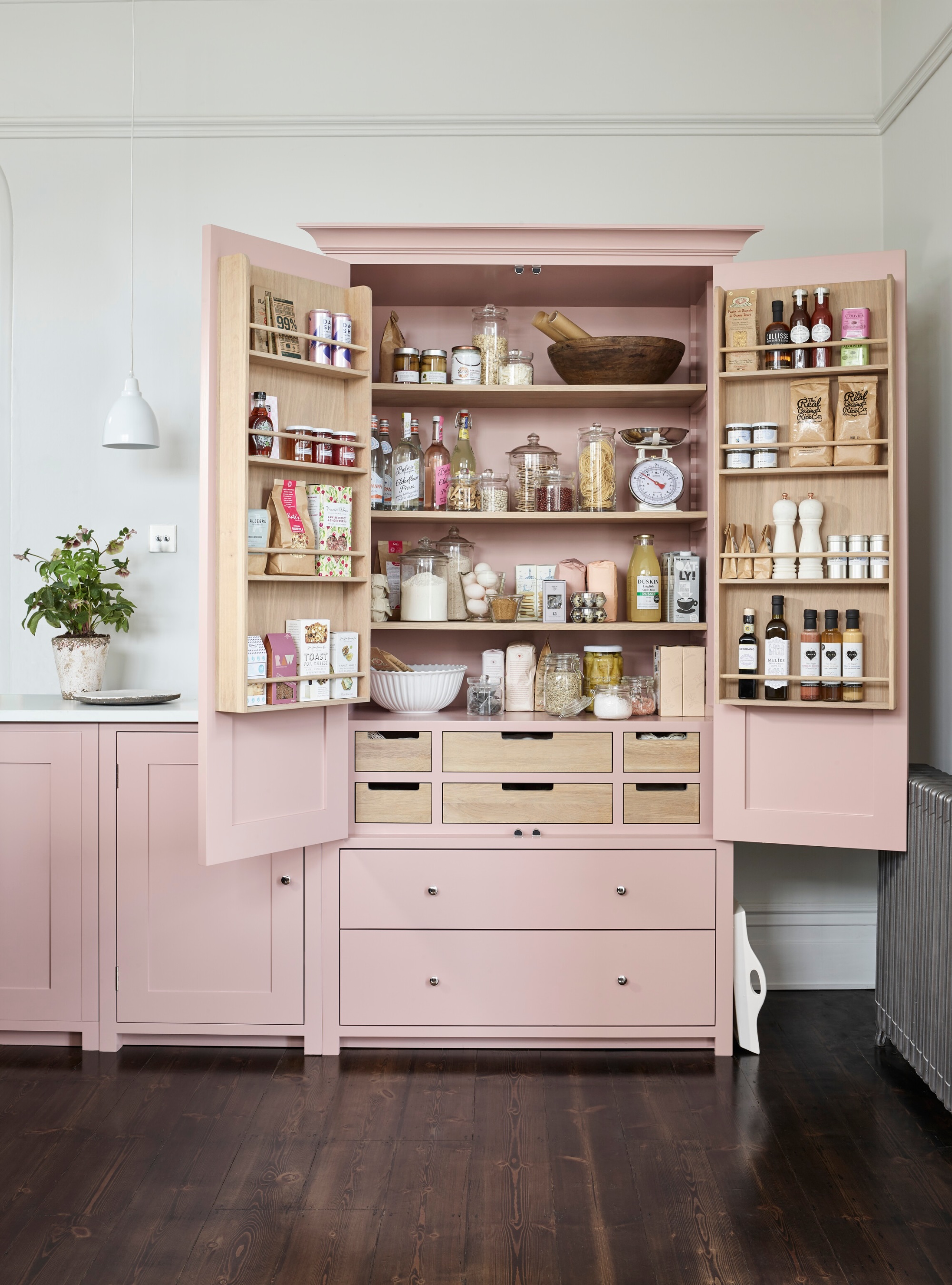 Hidden storage in a pink kitchen by Neptune