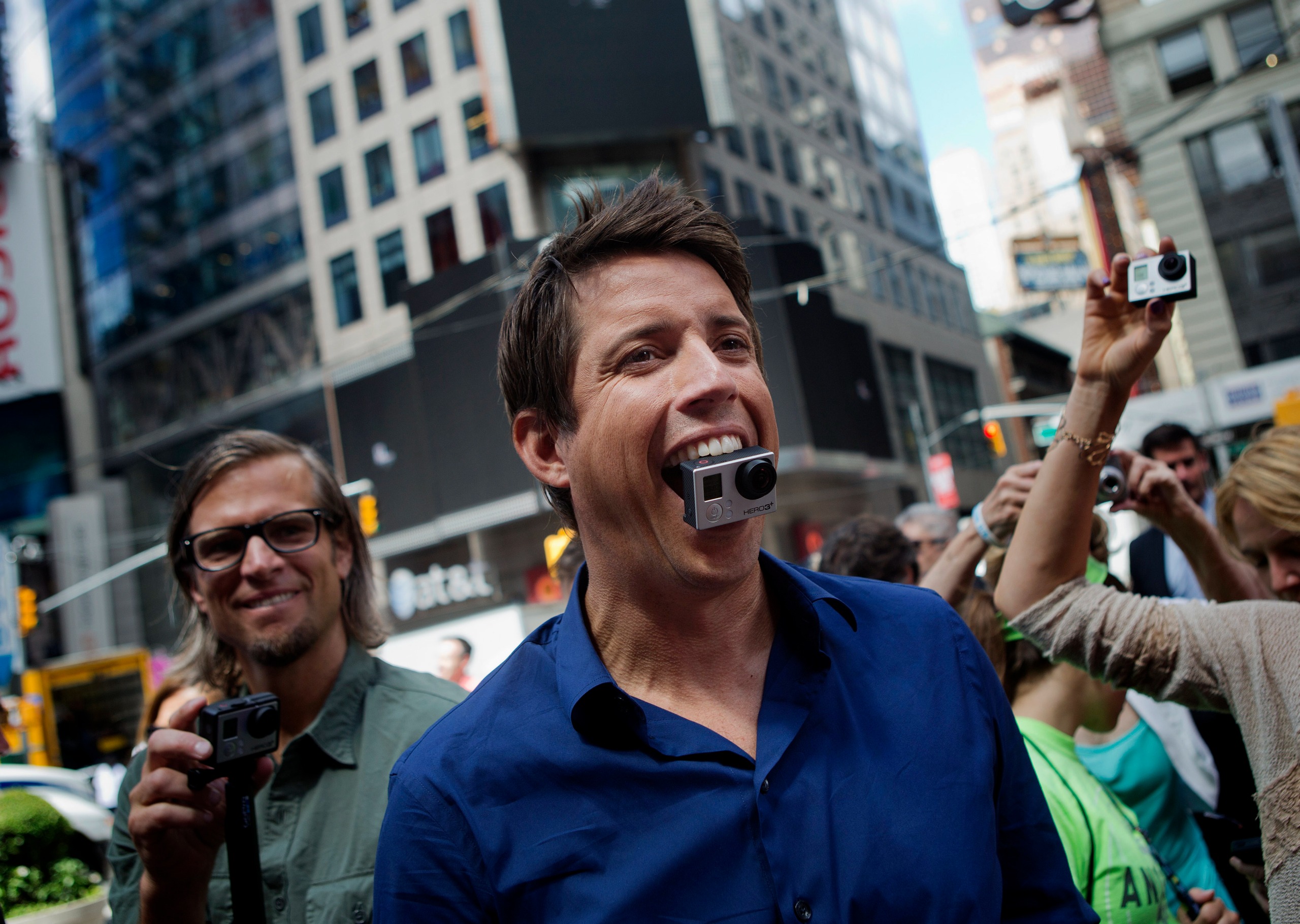 Nick Woodman, founder and chief executive officer of GoPro Inc., stands for a photograph with a GoPro Hero 3+ camera in his mouth after ringing the opening bell for the release of the company's IPO at the Nasdaq MarketSite in New York, U.S., on Thursday, June 26, 2014