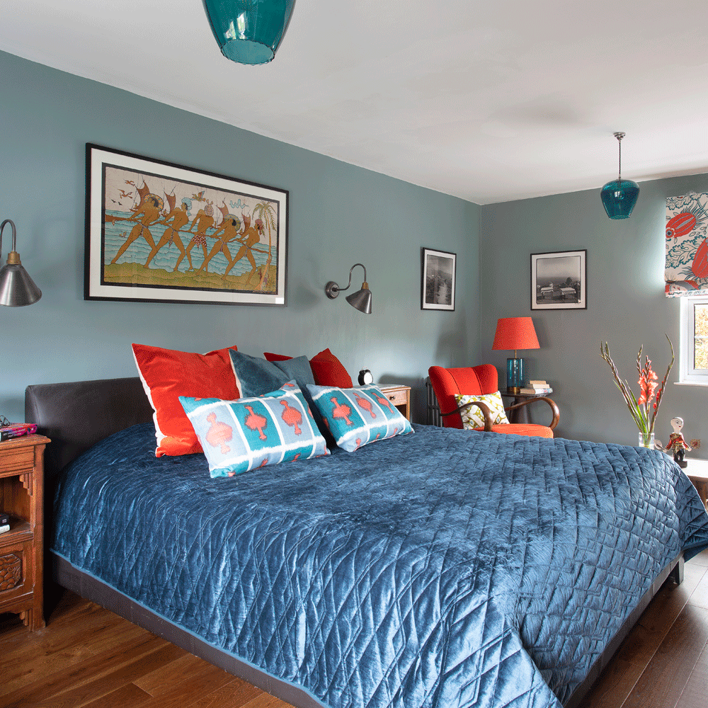 master bedroom with bed and cushions and wooden flooring