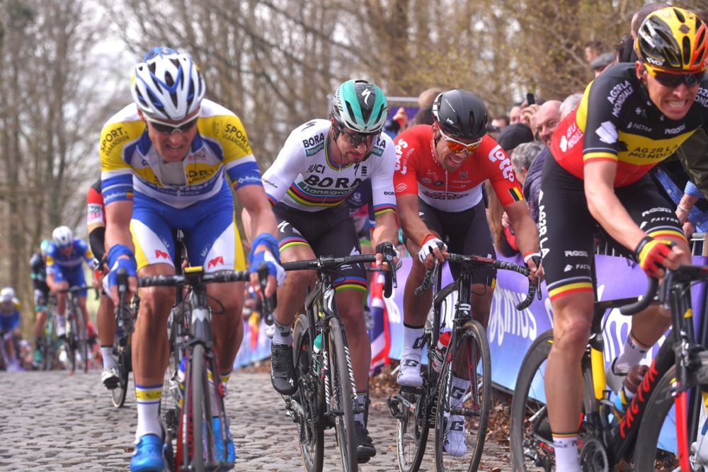 Sagan bumps shoulders on the cobbles as he fights for position