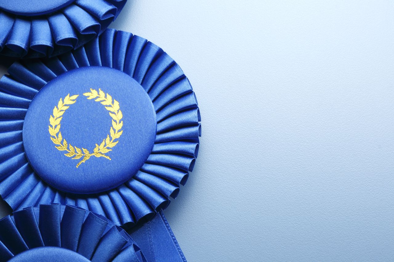 three dark blue ribbons lined up against light blue background