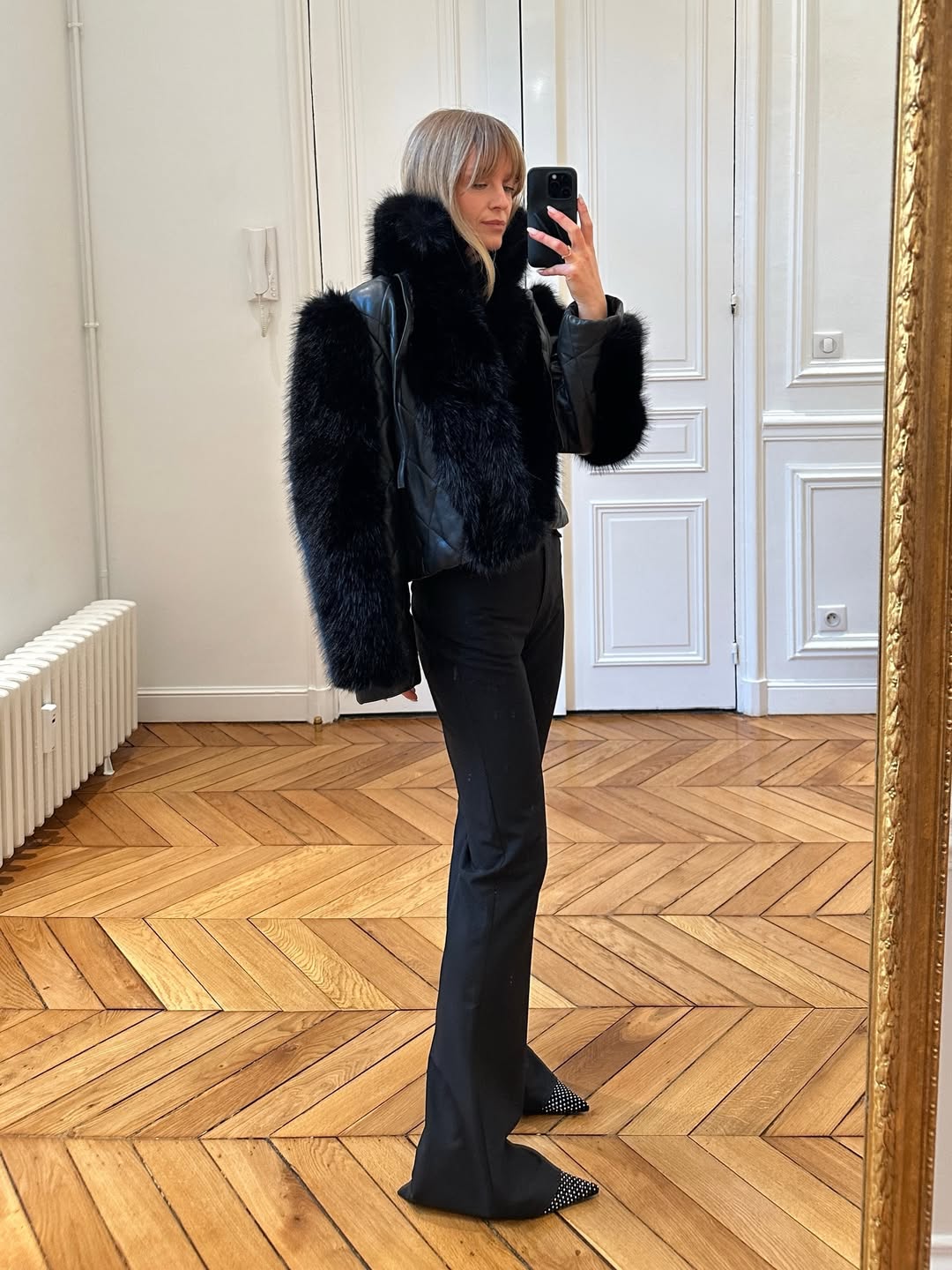 All black outfit with pointed toe shoes.