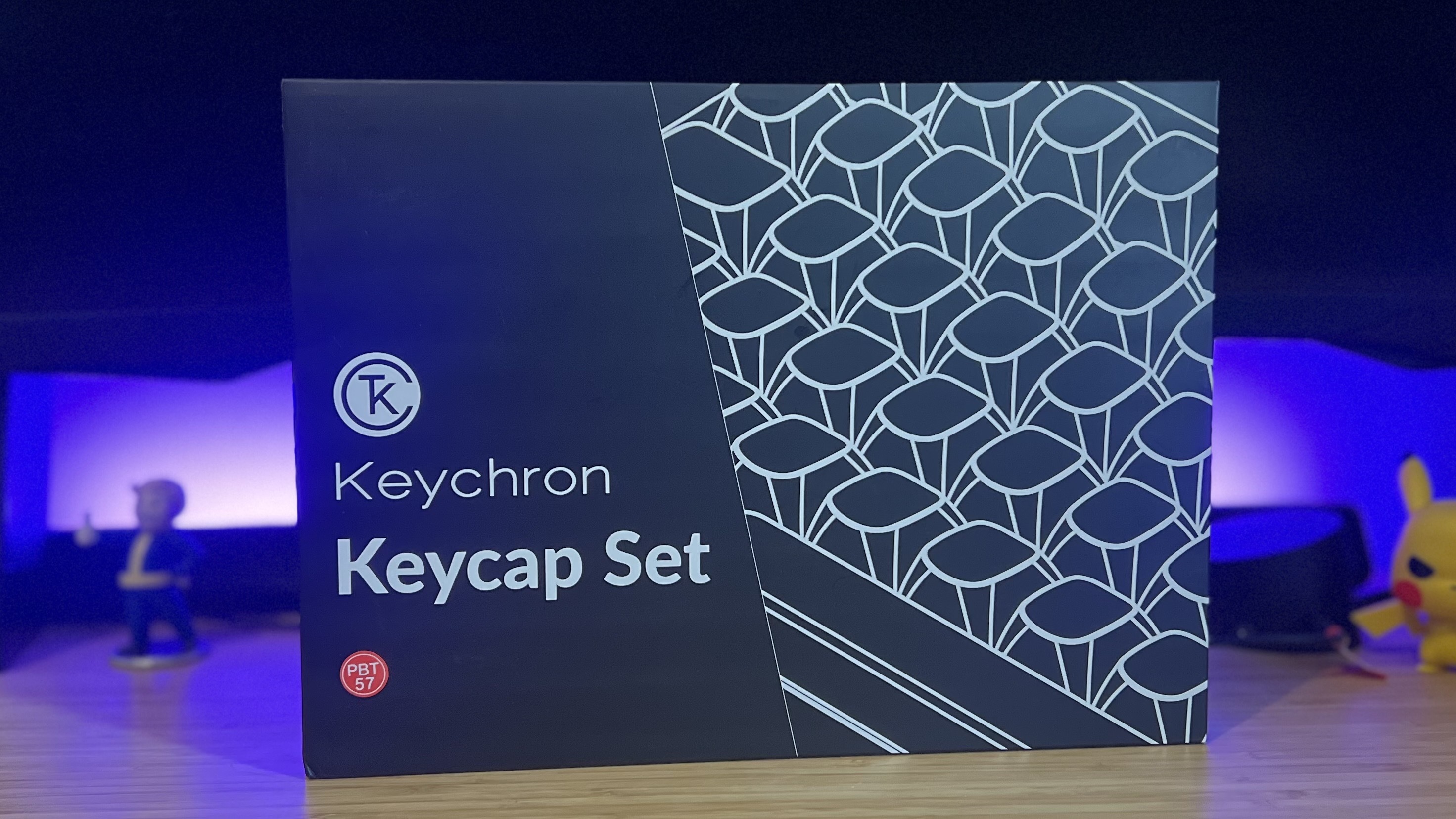 Keychron PBT keycap set on a wooden desk with purple lighting