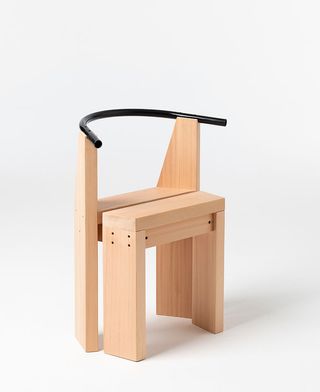 Chair made of natural wooden parts with black curved back