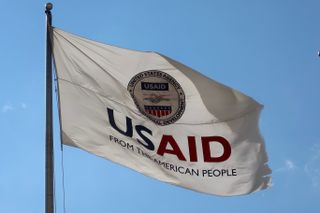 USAID flag flying over a blue sky