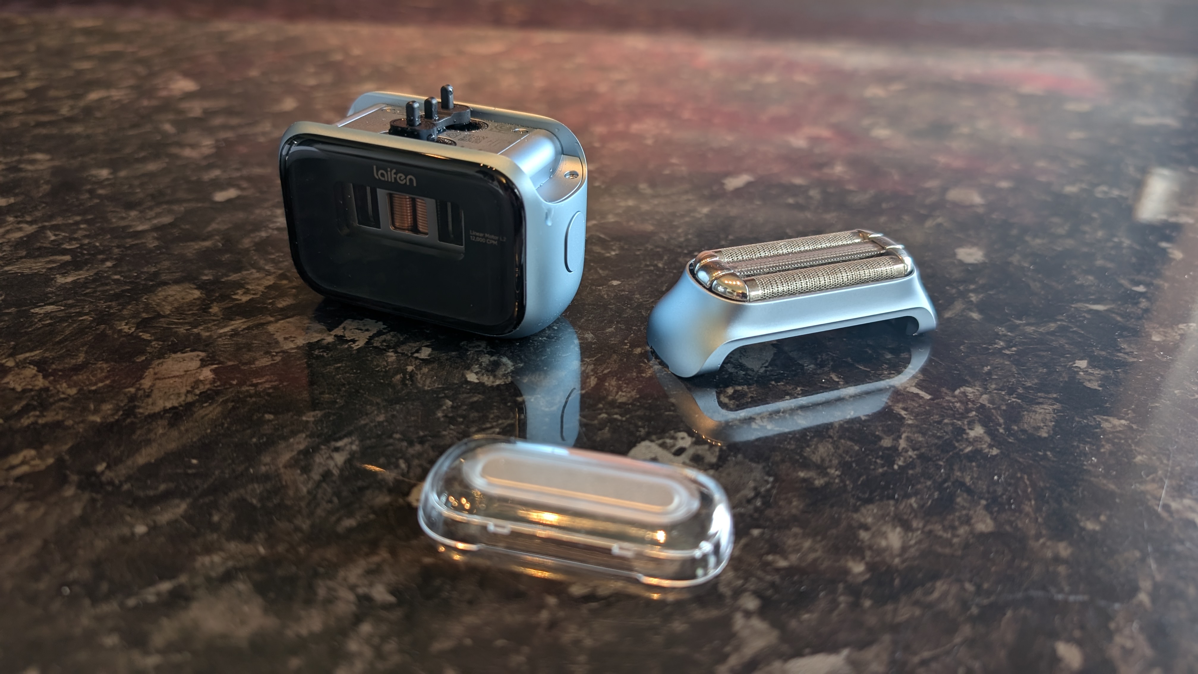 The Laifen P3 Pro electric travel shaver pictured on a dark marble worktop.