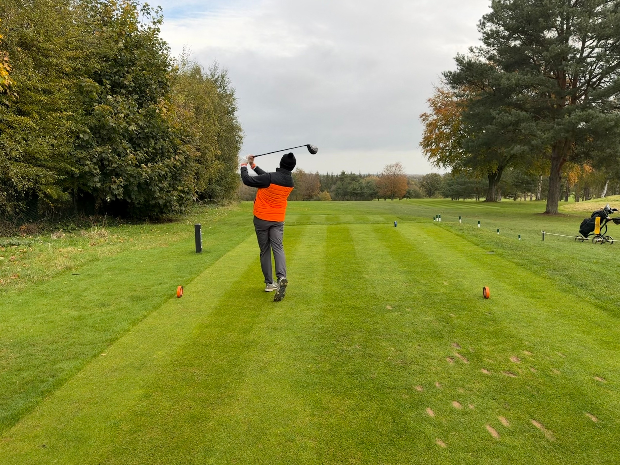 Baz Plummer in the finish position with driver on a cold, wet day on the golf course