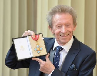 Denis Law with his CBE medal