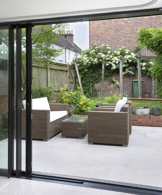 Outdoor living area with grass and white flowers