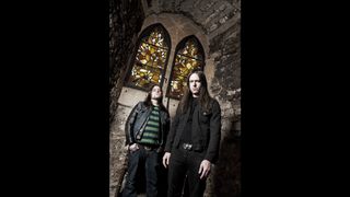 Two moody looking musicians in a church crypt