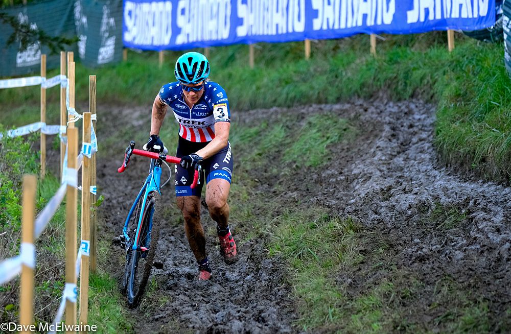Katie Compton (USA) running a long muddy stretch while in first place