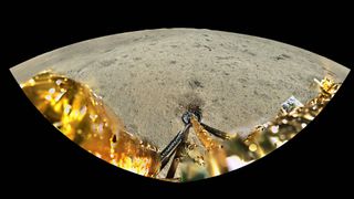 a wide angle view from the top of a lander on the moon, gazing down a gold foiled landing leg before an outstretched grey barren landscape.