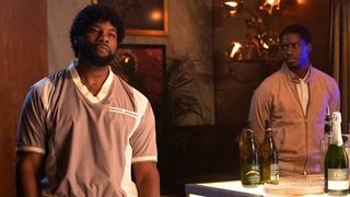 Amin Joseph and Damson Idris as Jerome and Franklin standing around a bar in Snowfall