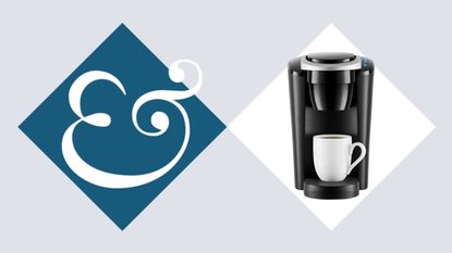 A black Keurig K-Compact coffee machine with a white mug under the spout.