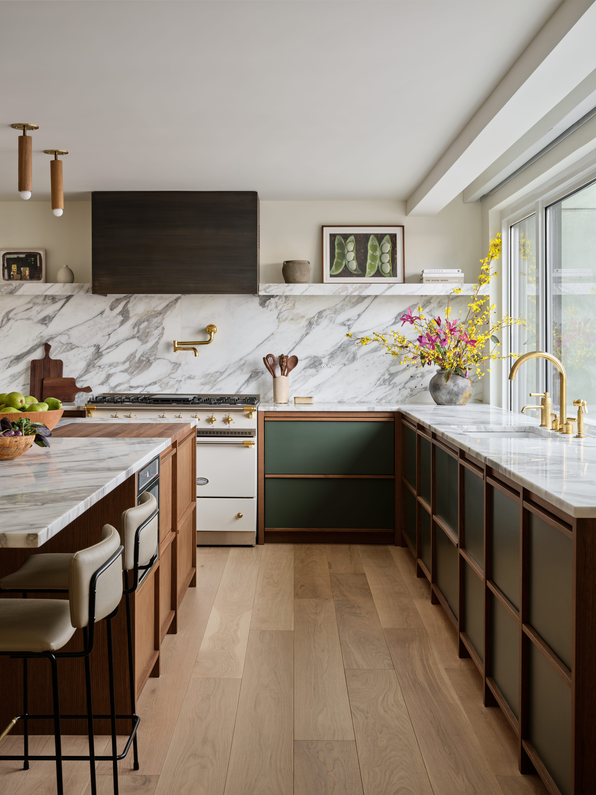 a contemporary kitchen with walnut cabinetry and a stone benchtop
