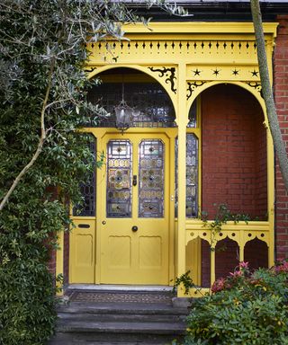 front door and surrounding porch painted yellow