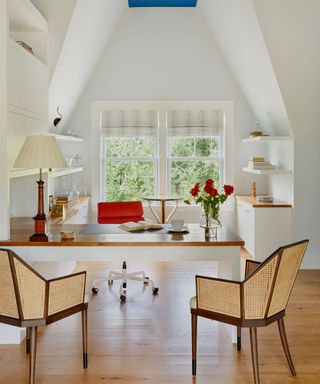 Light white home office in attic with attic window