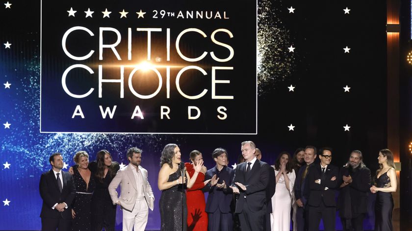 The cast and crew of Oppenheimer on stage receiving an award at the 2024 Critics Choice Awards