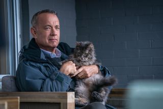 Tom Hanks on set of A Man Called Otto with a cat on his lap