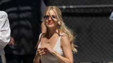 Sienna Miller walking with sunglasses and white t-shirt