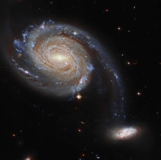 This photo from the Hubble Space Telescope shows two galaxies, NGC 7752 and NGC 7753, interacting as a single object called Arp 86 220 million light-years from Earth in the constellation Pegasus.