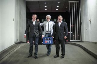 Karl Lagerfeld standing with two people