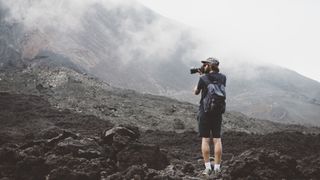 Young man photographing the Pacaya volcano, Antigua, Guatemala