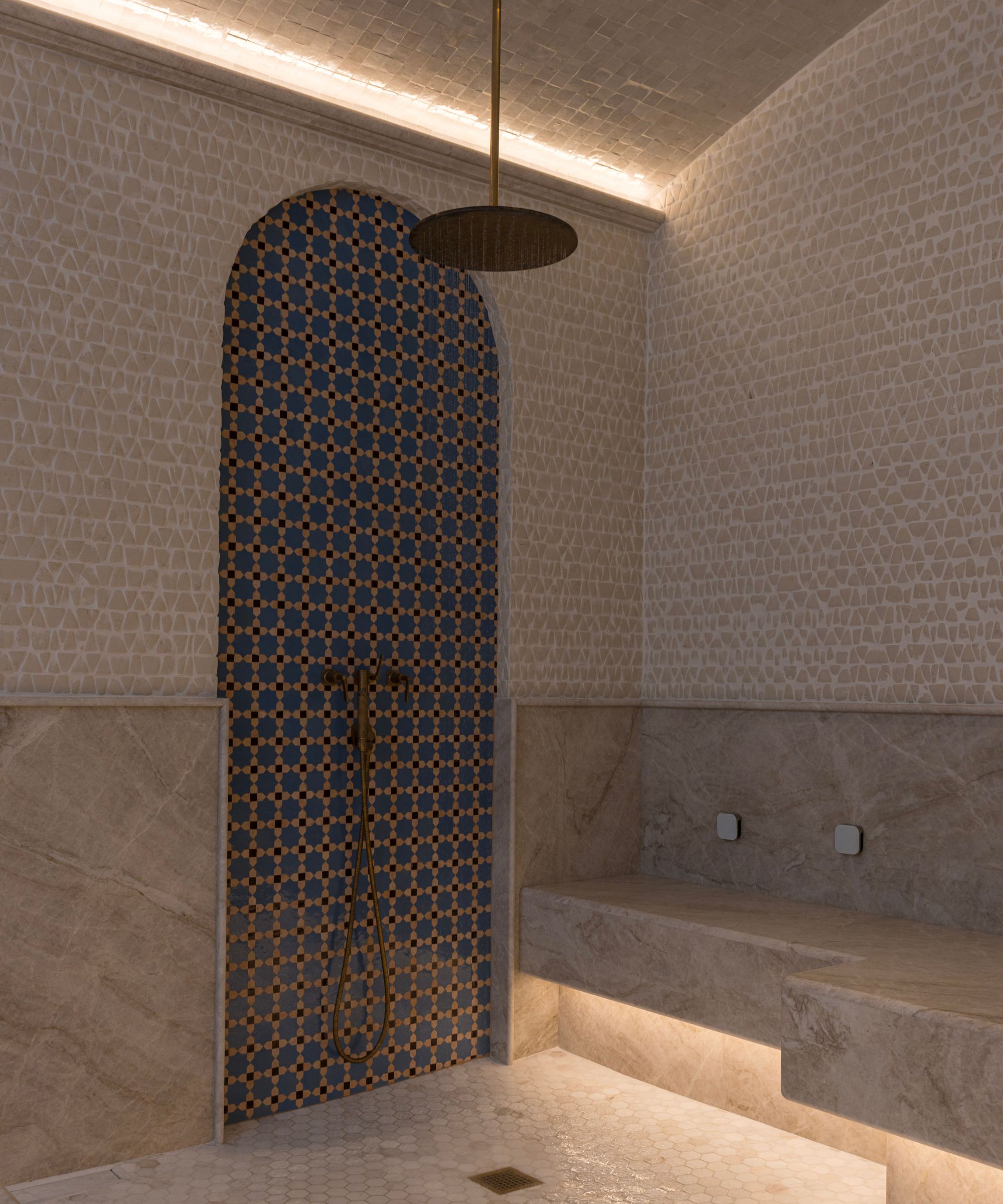 A large shower room decorated with mosaic tiles