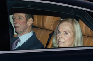 The Duke and Duchess of Kent riding in a car with tan leather seats