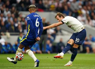 Harry Kane, right, takes a shot under pressure from Chelsea's Thiago Silva