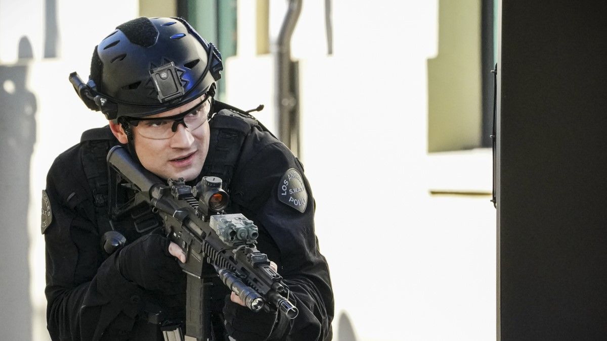 SWAT team member holding a gun in crouching position on CBS&#039; SWAT