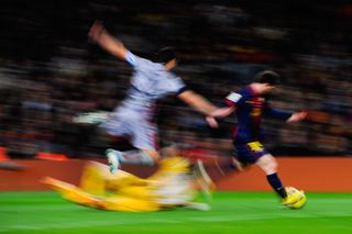 Lionel Messi scores his third goal and Barcelona's fourth in a 5-1 win over Osasuna at Camp Nou in January 2013.