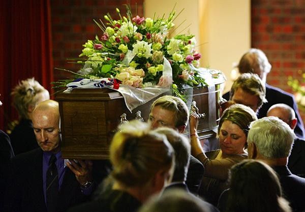 Simon Gillett (L) carries the coffin of Amy with Amy's AIS friend Tammy Ebert
