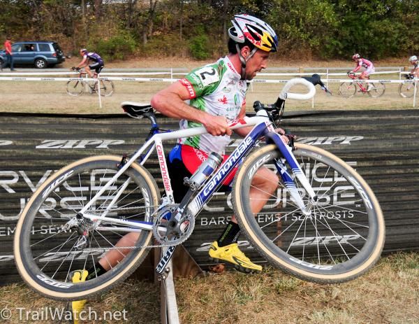 Tim Johnson (Cannondale-cyclocrossworld.com) running the barriers in third place.