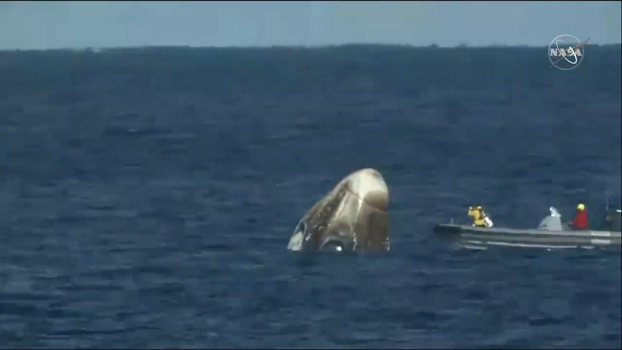 Recovery teams reach SpaceX's first Crew Dragon in the Atlantic Ocean after its succesful splashdown.