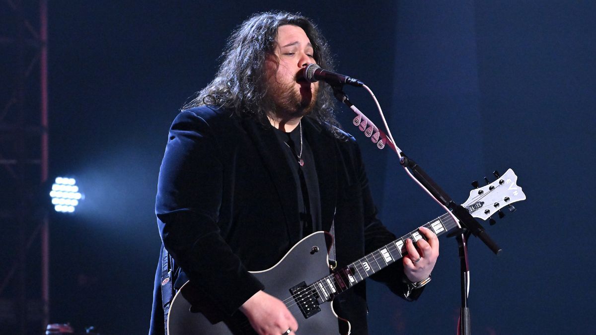 Wolfgang Van Halen playing guitar and singing on stage