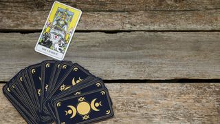 The Chariot and other tarot cards on wooden table, flat lay.