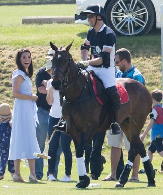 Prince William playing Polo with wife Kate Middelton watching