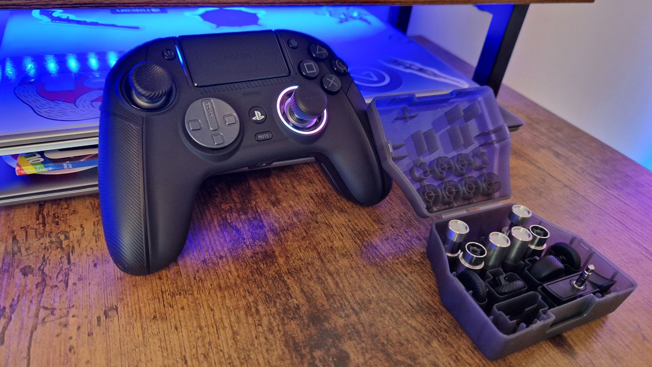 Nacon Revolution 5 Pro with its RGB light ring on and its box of attachments open next to it