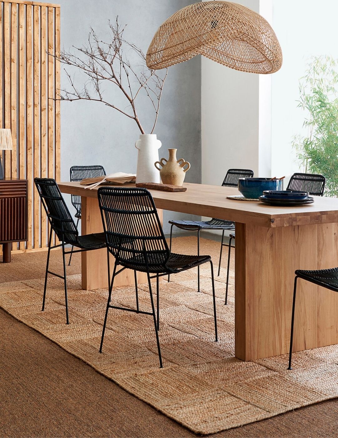 Malcan Jute Rug in a wood-clad living room with soft tones and black chairs.