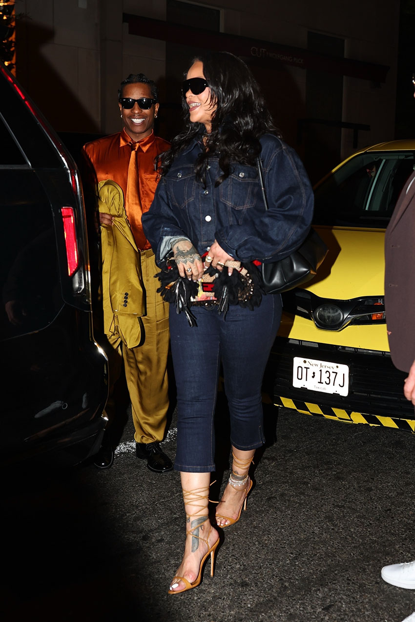 Rihanna wearing a dark denim cropped jacket, cropped denim jeans, and strappy heels