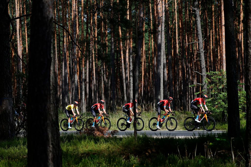 PRZEMYSL POLAND AUGUST 10 Phil Bauhaus of Germany and Team Bahrain Victorious Yellow Leader Jersey and Teammates in The Peloton passing through a forest during the 78th Tour de Pologne 2021 Stage 2 a 201km stage from Zamo to Przemyl 341m TourdePologne TDP2021 UCIWT on August 10 2021 in Przemysl Poland Photo by Bas CzerwinskiGetty Images
