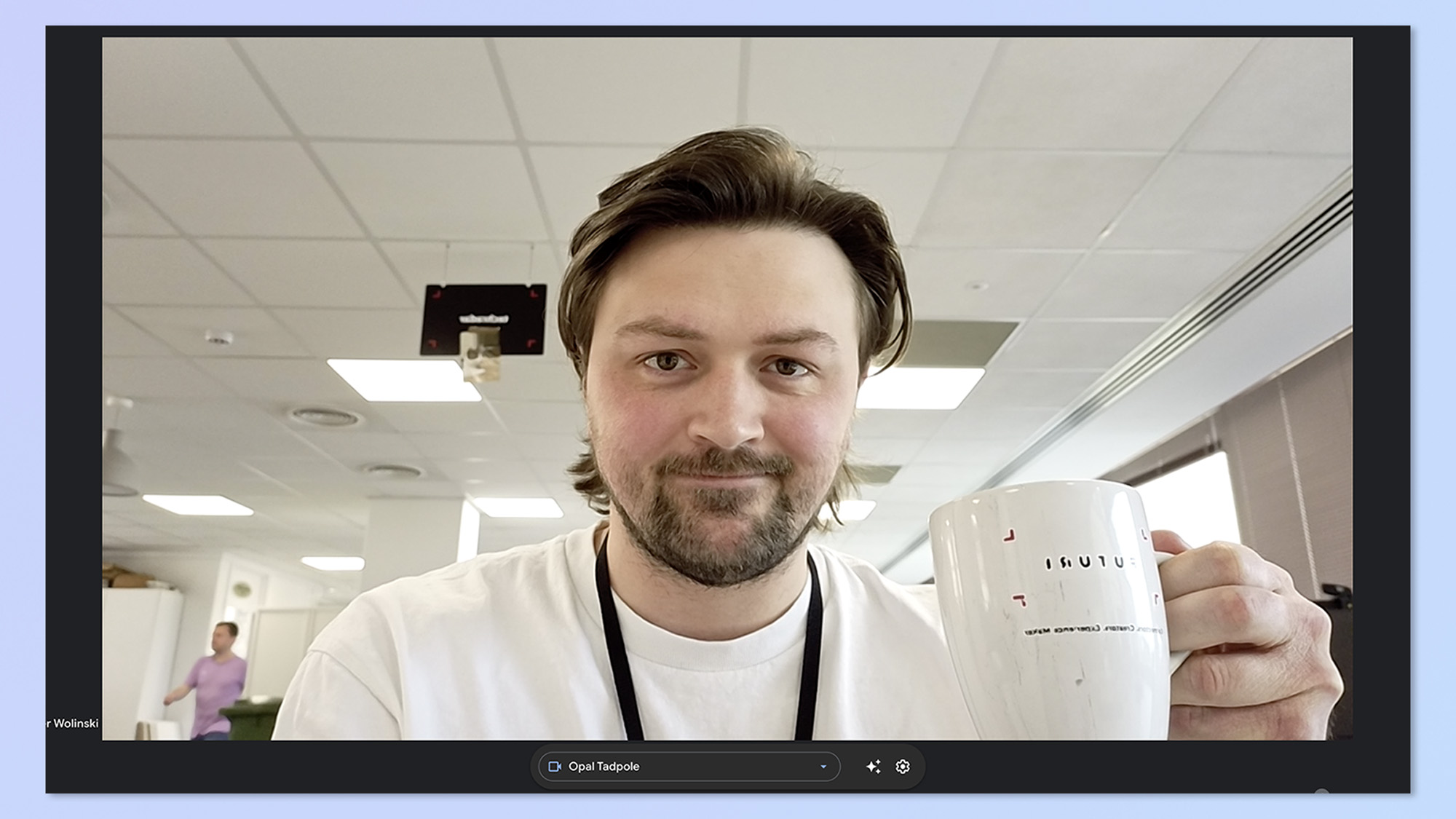 A screenshot of author Peter Wolinski, holding up a mug while on a video call. This screenshot shows the image of the Opal Tadpole webcam.
