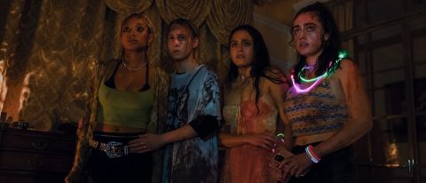 Bee, Sophie, Emma, and Alice are covered in blood and wounds as they stare at something off screen in Bodies Bodies Bodies