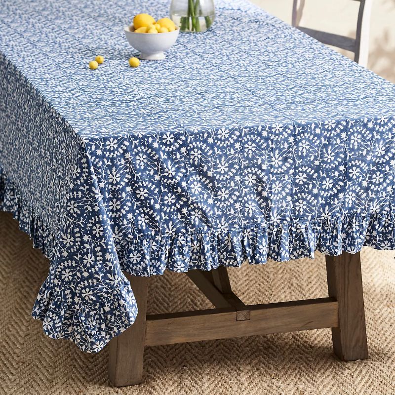 blue and white floral tablecloth with ruffled edge