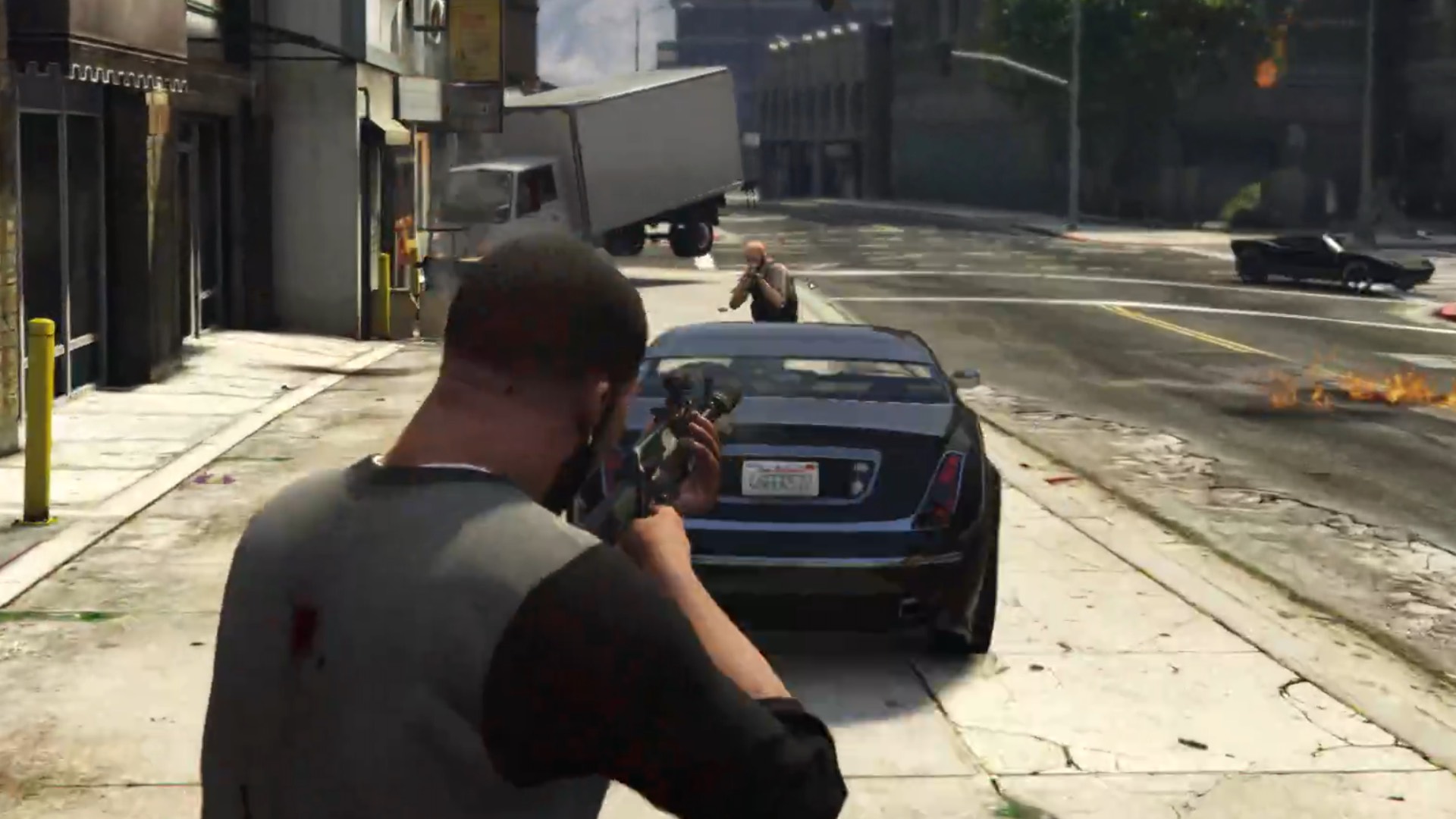 Franklin fires a car at a hitman.