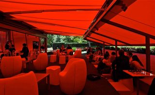 Seating area glowing red from the fabric above