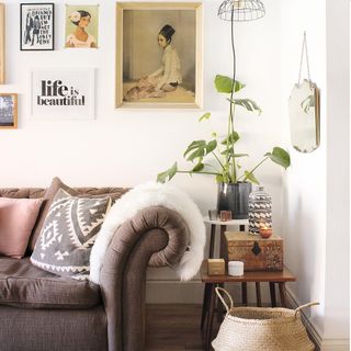 living room with sofa white walls and wooden flooring