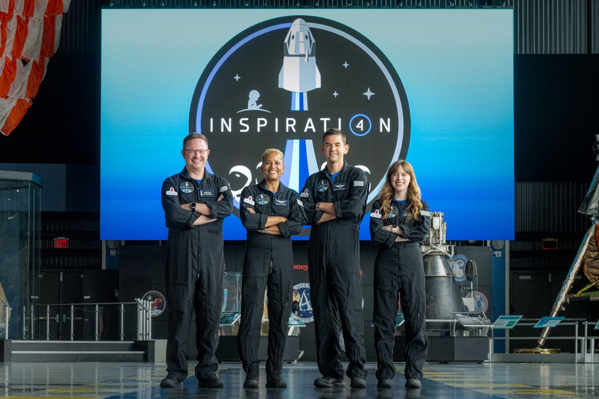 SpaceX's Inspiration4 crew pose for a group photo with their mission emblem at the U.S. Space and Rocket Center in Huntsville, Alabama.